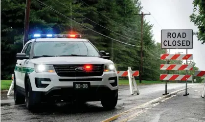  ?? Photograph: Tom Gralish/AP ?? A road is closed in Upper Makefield, Pennsylvan­ia, on Sunday following fatal flash flooding on Saturday.