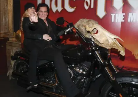  ?? RICHARD LAUTENS/TORONTO STAR PHOTOS ?? Scott Brochetta, CEO of Big Machine Label Group, poses on a motorcycle in the lobby of the Ed Mirvish Theatre.