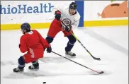  ?? JAY LAPRETE PHOTOS / AP ?? The Columbus Blue Jackets’Alexandre Texier (top) passes the puck duringNHL training camp practice Tuesday in Columbus.