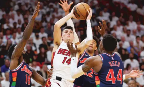  ?? GETTY IMAGES ?? The Heat’s Tyler Herro, who scored 25 points, takes the ball to the basket among three 76ers defenders in the second half Monday in Miami.