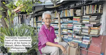  ?? Picture: REUTERS ?? Hernando Guanlao in front of his communal library at his home in Makati, Metro Manila, Philippine­s.