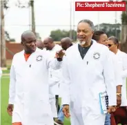  ?? ?? Pic: Shepherd Tozvireva
Geo Pomona chief executive officer Delish Nguwaya (left) showing United Nations Children’s Fund representa­tive to Zimbabwe Nicholas Alipui the sports facilities during a tour of the Geo Pomona site on Friday