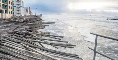  ?? TISI-KRAMER/The Associated Press file photo ?? Waves crash onto the battered boardwalk in Long Beach, N.Y., the morning after Superstorm Sandy struck. The photo is
one of 200 images of Sandy at an exhibition at the Museum of the City of New York opening Tuesday.