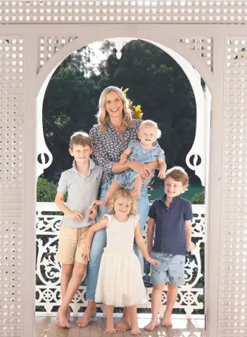  ?? ?? Champion netballer Laura Geitz with husband Mark Gilbride and their four children Barney, Franky, Billie and Pippa on their Brookfield property; and Geitz in uniform as the Queensland Firebirds captain. Pictures: David Kelly