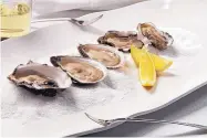  ?? E. JASON WAMBSGANS/CHICAGO TRIBUNE ?? Oysters make the simplest starter — just shuck and eat. A bottle of bubbly is all you need.