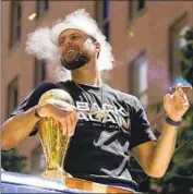  ?? Eric Risberg Associated Press ?? STEPHEN CURRY enjoys a cigar during the Golden State Warriors’ NBA title parade in San Francisco.