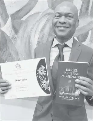  ?? ?? Michael Jordan poses with his award winning novel and his Guyana Prize for Literature certificat­e of award