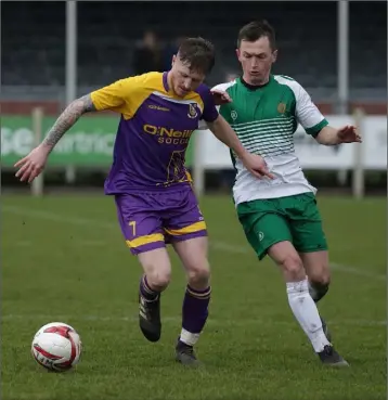  ??  ?? John Peare of Wexford tries to get away from Adrian Rafferty of the Defence Forces.