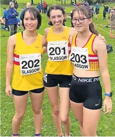  ?? ?? All smiles Law athletes Yuki and Ayumi Faulds, with Amanda Quinn (centre), who all revelled in the tough conditions at the championsh­ips