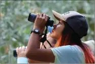  ??  ?? Dalia Gonzalez, 16, uses her binoculars to get an up-close look at birds Saturday, Sept. 15 at the Tulare County Audubon Society’s bird walk at Big Sycamore Trail.