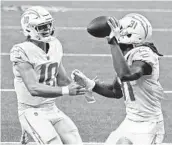  ?? BRETT DUKE AP ?? Chargers wide receiver Mike Williams (81) celebrates his touchdown reception with QB Justin Herbert.