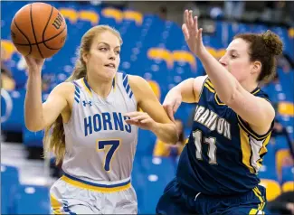  ?? @IMartensHe­rald Herald photo by Ian Martens ?? University of Lethbridge Pronghorns’ Danielle Fritzke looks to move the ball up the baseline past Brandon University Bobcats’ Stephanie Hunter during Canada West basketball action this weekend at the 1st Choice Savings Centre.