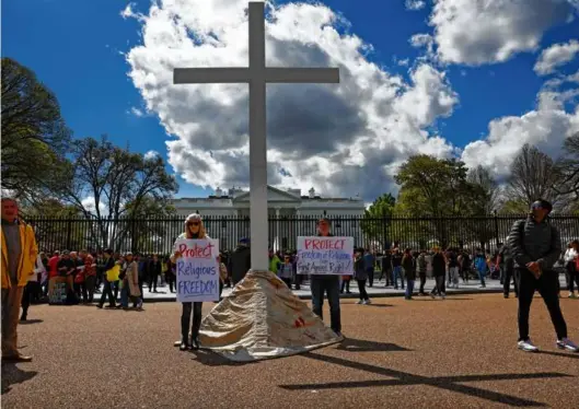  ?? ANNA MONEYMAKER/GETTY IMAGES ?? MESSAGE ON RELIGION — The Rev. Patrick Mahoney (right), director of the Christian Defense Coalition, led a demonstrat­ion for religious freedom in front of the White House on Thursday. Participan­ts in the event brought a 15-foot cross to Pennsylvan­ia Avenue and led group prayers.