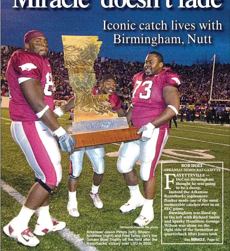  ?? Democrat-Gazette file photo ?? Arkansas’ Jason Peters (left), Shawn Andrews (right) and Fred Talley carry the Golden Boot Trophy off the field after the Razorbacks’ victory over LSU in 2002.