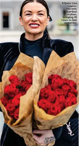  ?? ?? Tribute: Lisa Lawlor, the only Stardust orphan, bringing 49 roses to Dáil yesterday