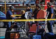  ?? FRANCINE ORR / LOS ANGELES TIMES / TNS ?? A woman has her vitals checked at a triage area Saturday during a hostage situation after police pursuit ended in Silver Lake, Calif.