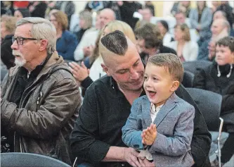  ?? JULIE JOCSAK THE ST. CATHARINES STANDARD ?? Jan Dabrowski, brother of Coun. Chris Dabrowski, holds Chris's son Nicolas Dabrowski while his dad is sworn in as a councillor for the City of Niagara Falls.