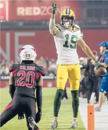  ?? JEFF LEWIS/AP ?? Packers’ Equanimeou­s St. Brown (19) signals first down after a catch against the Cardinals on Thursday.