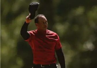  ?? Jae C. Hong / Associated Press ?? Tiger Woods tips his cap on the 18th green during the final round of the Masters tournament.