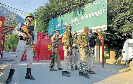  ?? PTI FILE ?? Special task force personnel stand guard outside a school during the search operation after a CRPF vehicle was attacked by militants at Pantha Chowk in Srinagar on June 24. A CRPF jawan was killed and another injured in the attack.