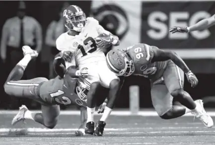  ??  ?? Alabama wide receiver ArDarius Stewart is tackled by Florida defensive lineman Jachai Polite (99) and linebacker Daniel McMillian during the Southeaste­rn Conference championsh­ip game Saturday in Atlanta. John Bazemore, The Associated Press