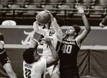  ?? Vasha Hunt / Associated Press ?? Ciera Johnson, right, and No. 3 Texas A&M edged Alabama on Thursday to enter today’s game with a 21-1 record (12-1 SEC).