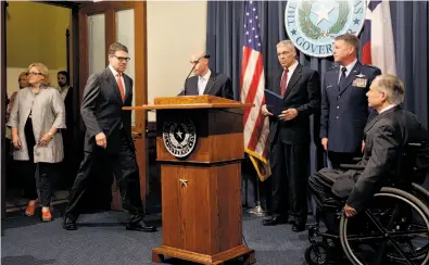  ?? Eric Gay / Associated Press ?? In Austin, Texas, Gov. Rick Perry (second from left) said he is deploying 1,000 National Guard troops.