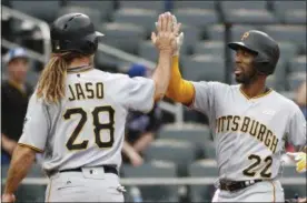  ?? KATHY WILLENS — ASSOCIATED PRESS ?? Andrew McCutchen, right, is greeted by teammate John Jaso after hitting a three-run homer in the ninth inning of Sunday’s game.