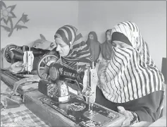  ??  ?? Kashmiri girls stitching cloth during their class in the women’s market.