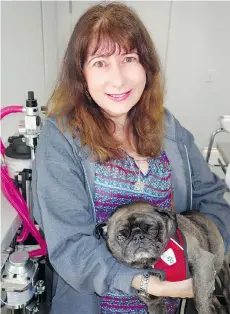  ??  ?? RAPS Animal Hospital president Fearn Edmonds took adopted six-year-old pug Hymie to the Richmond facility’s opening.