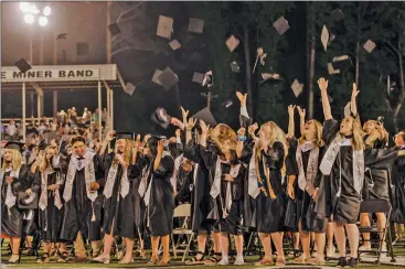  ?? CHRISTIE HEIDELBERG/ Special to The Saline Courier ?? Bauxite graduates toss their caps in the air after graduating in late May at The
Pit in Bauxite.