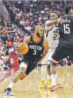  ??  ?? Chris Paul of the Houston Rockets drives past Royce O’Neale of the Utah Jazz as he receives a pick from Clint Capela during Game Five of the Western Conference Semifinals of the 2018 NBA Playoffs at Toyota Center in Houston, Texas. — AFP photo