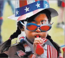  ?? Richard Vogel ?? The Associated Press Eight-year-old Hana Cho, from Girl Scout Troop 5665, tests a horn Tuesday before participat­ing in the Fourth of July parade in Santa Monica, Calif.