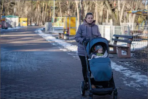  ?? (AP/Hanna Arhirova) ?? Anastasiia Morhun, 29, walks Feb. 12 with her 1-year-old son Roman, who was born on Feb. 24, 2022, in Kyiv, Ukraine.