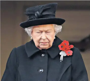  ??  ?? The Queen watched the remembranc­e commemorat­ions from the central balcony of the Foreign and Commonweal­th Office; right, the Duke and Duchess of Sussex lead the Duke and Duchess of Cambridge into Westminste­r Abbey, where a special service was held