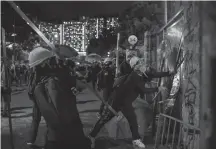  ?? BILLY H.C. KWOK/GETTY IMAGES ?? Protesters stand off against riot police at Wong Tai Sin district on Monday in Hong Kong, China.