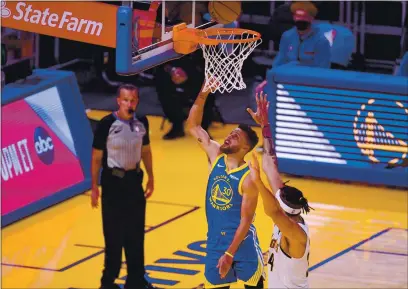  ?? JOSE CARLOS FAJARDO — BAY AREA NEWS GROUP ?? The Warriors’ Stephen Curry makes a basket past the Nuggets’ JaVale McGee in the first quarter on Monday at Chase Center in San Francisco. With that basket, Curry surpassed Wilt Chamberlai­n as the Warriors’ all-time leading scorer.