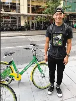  ?? NOMAD TECHNOLOGI­ES ?? Nomad Technologi­es hires students, commuters and eventgoers to carry iPads featuring advertisin­g around with them as they walk. The “nomad” pictured here is advertisin­g LimeBike, the “ride anytime” bike-sharing company that recently launched a...