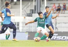  ??  ?? In the thick of the action is Sufizal vying with PBMM-PBSM FC defenders just moments before scoring during the FAM Cup match.