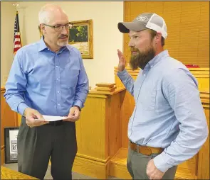  ?? PDN photo by David Seeley ?? City of Poteau iegal Counsel Marc Bovos, right, swears in new Poteau City Councilman B.J. Johnson at the end of Monday night’s Poteau City Council meeting at Poteau City Hall. Johnson was appointed to the Seat 2, Ward 1 spot that belonged to Clay Bennett, who passed away March 1 after a short illness.