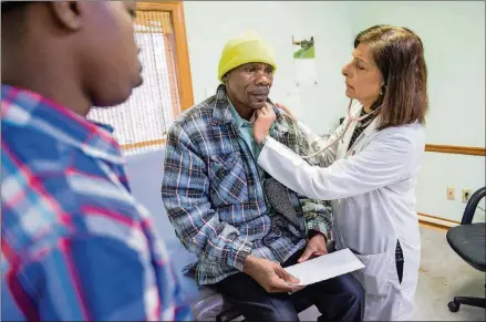  ?? CONTRIBUTE­D PHOTOS BY BITA HONARVAR ?? At the Clarkston Community Health Center, Gulshan examines Simeon Gahungu, a Burundian who came to the U.S. as a refugee from Tanzania.