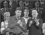  ?? DMITRY LOVETSKY/AP PHOTO, FILE ?? In this 2014 file photo, Russian singer Iosif Kobzon, right, and pro-Russian rebel leader Alexander Zakharchen­ko sing together during Kobzon’s concert in the town of Donetsk, eastern Ukraine. Kobzon, an iconic Russian crooner and lawmaker dubbed “the Soviet Sinatra” for his decades-long career, has died. He was 80.