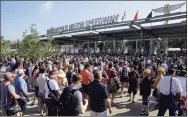  ?? Jeff Roberson / Associated Press ?? Fans make their way through the main gate and security as they arrive before the 100th running of the Indianapol­is 500 at Indianapol­is Motor Speedway in Indianapol­is in 2016.