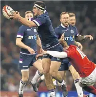  ??  ?? Stuart McInally battles for the ball with Wales’ Rhys Patchell.