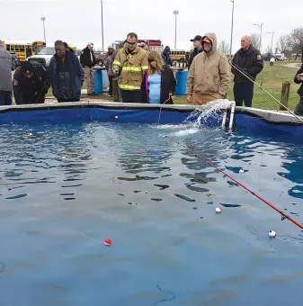  ?? Staff photo by Karl Richter ?? ■ Participan­ts and volunteers fish for trout from a tank during the 26th annual fishing derby for students with special needs on Thursday at Grady T. Wallace Park in Texarkana, Texas.