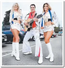  ??  ?? Elvis with his girls at the Cooly Rocks On street parade. Picture: SCOTT POWICK