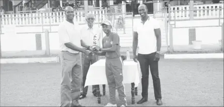  ??  ?? Shemaine Campbelle collects her player of the match trophy from former West Indies fast bowler Reon King while national selector Rayon Griffith, looks on.