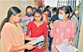  ?? — P. SURENDRA ?? An invigilato­r checks Intermedia­te students coming to write the exam at Sri Rama College at Kothapet in Hyderabad on Friday.