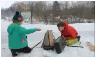  ?? LAUREN HALLIGAN — DIGITAL FIRST MEDIA FILE ?? Kids start a fire during Winterfest 2018 at Hudson Crossing Park in Schuylervi­lle.
