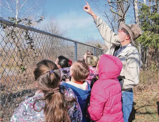  ?? Steve Kistler/Janet Kistler via AP ?? Steve Kistler teaches third graders at the Cub Run Elementary School in Kentucky about birds during the Great Backyard Bird Count in February 2012. The count is a citizen science project that collects data used by researcher­s to track bird population­s.